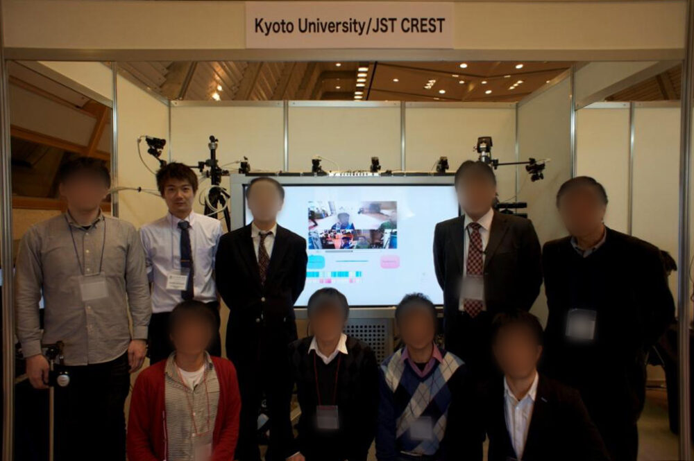 京都大学・JST CRESTのブースで、共同研究した仲間たちと集合写真