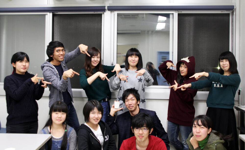 研究室のメンバーのみなさまと写真に写る飯島先生