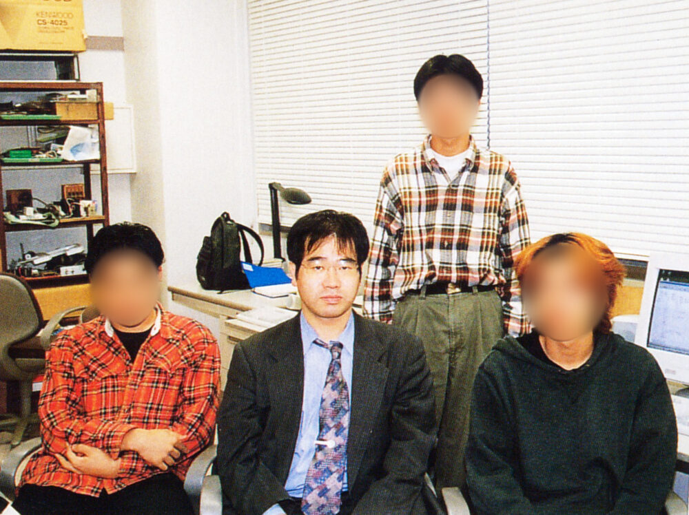 研究室の皆さまと写真に写る冨田先生